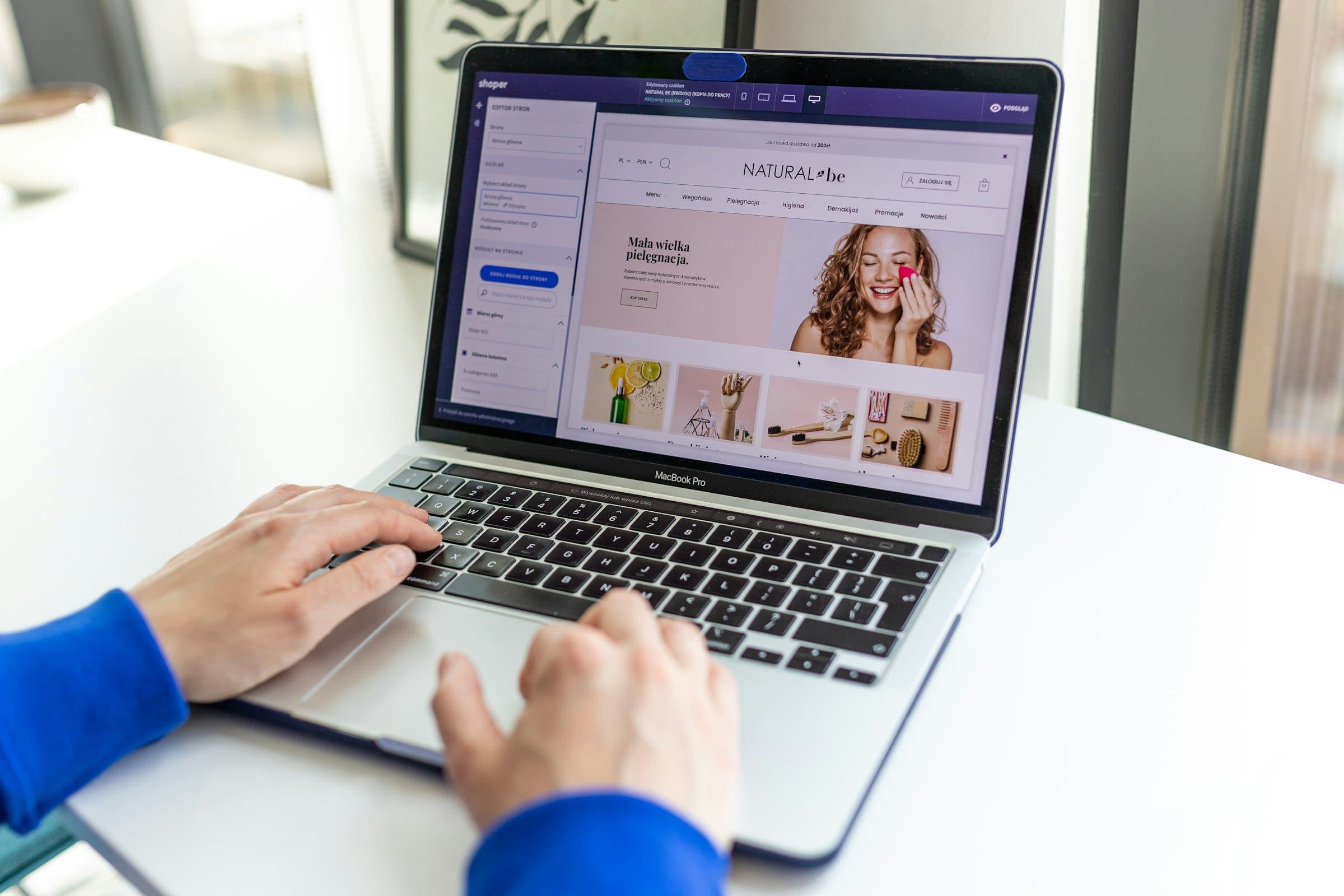 Person types on a laptop showing an online store product page